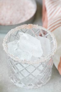 a glasses rimmed with pink salt