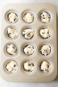 blueberry banana muffin batter in cupcake tin.