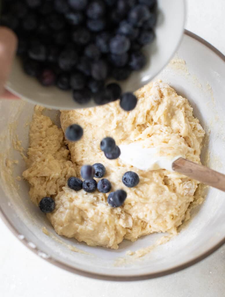 Fresh blueberries going into banana muffin batter.