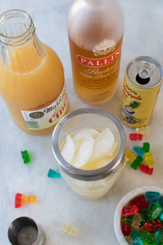 Ingredients for gummy bear shots on a marble counter