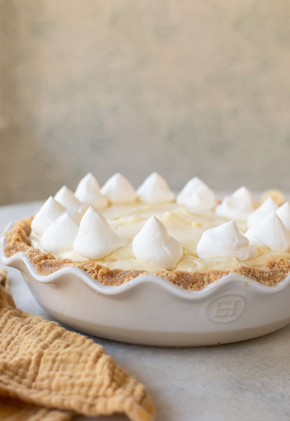 Banana cream pie with whipped cream in a pie dish with Nilla wafer cookie crust.