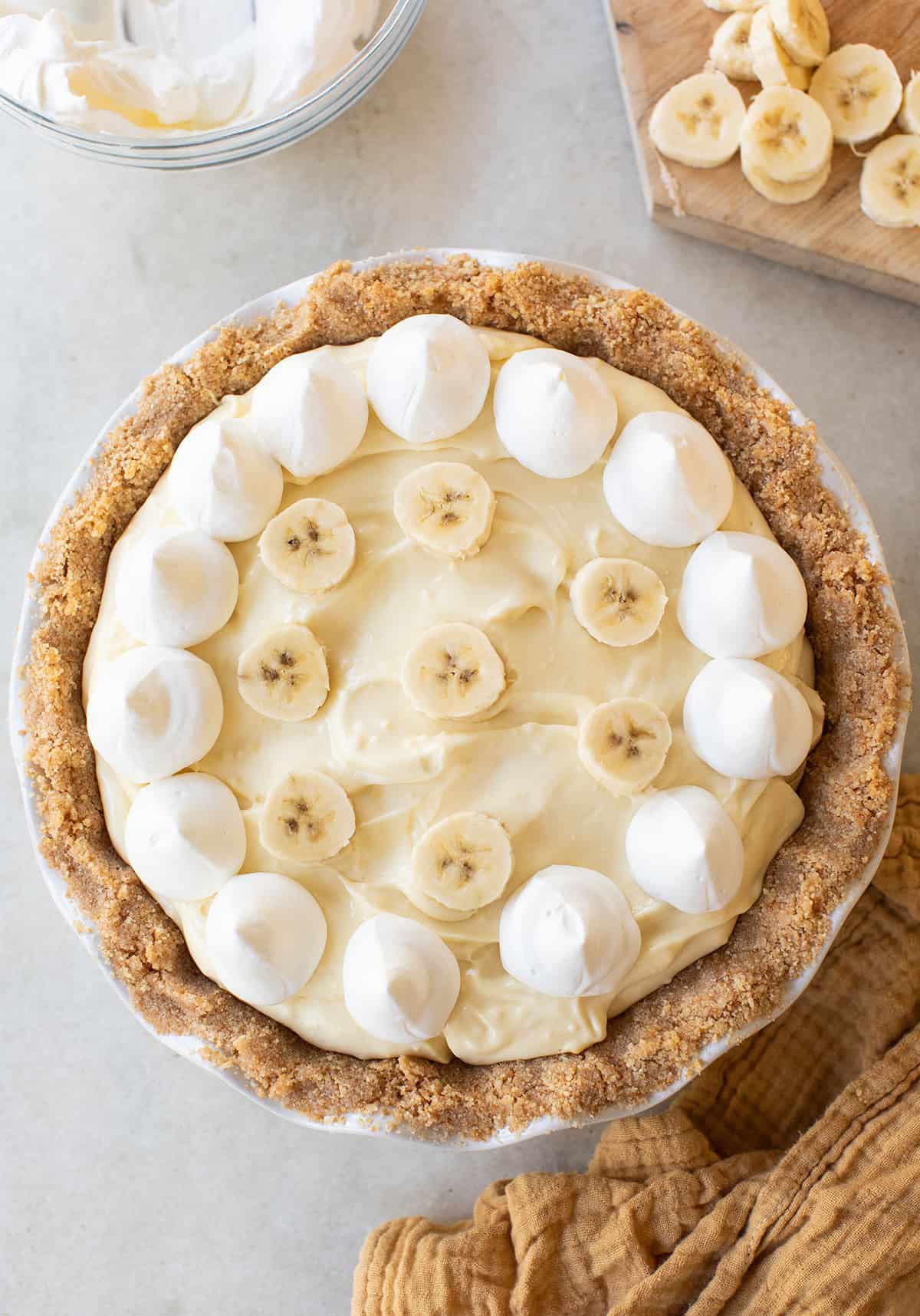 Banana pudding pie with whipped cream, sliced bananas and a Nilla wafer crust.