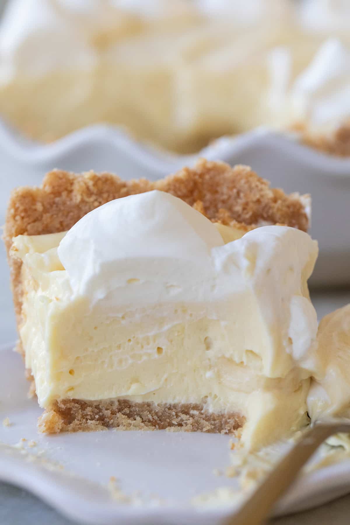 Homemade banana pudding pie with a slice taken out.