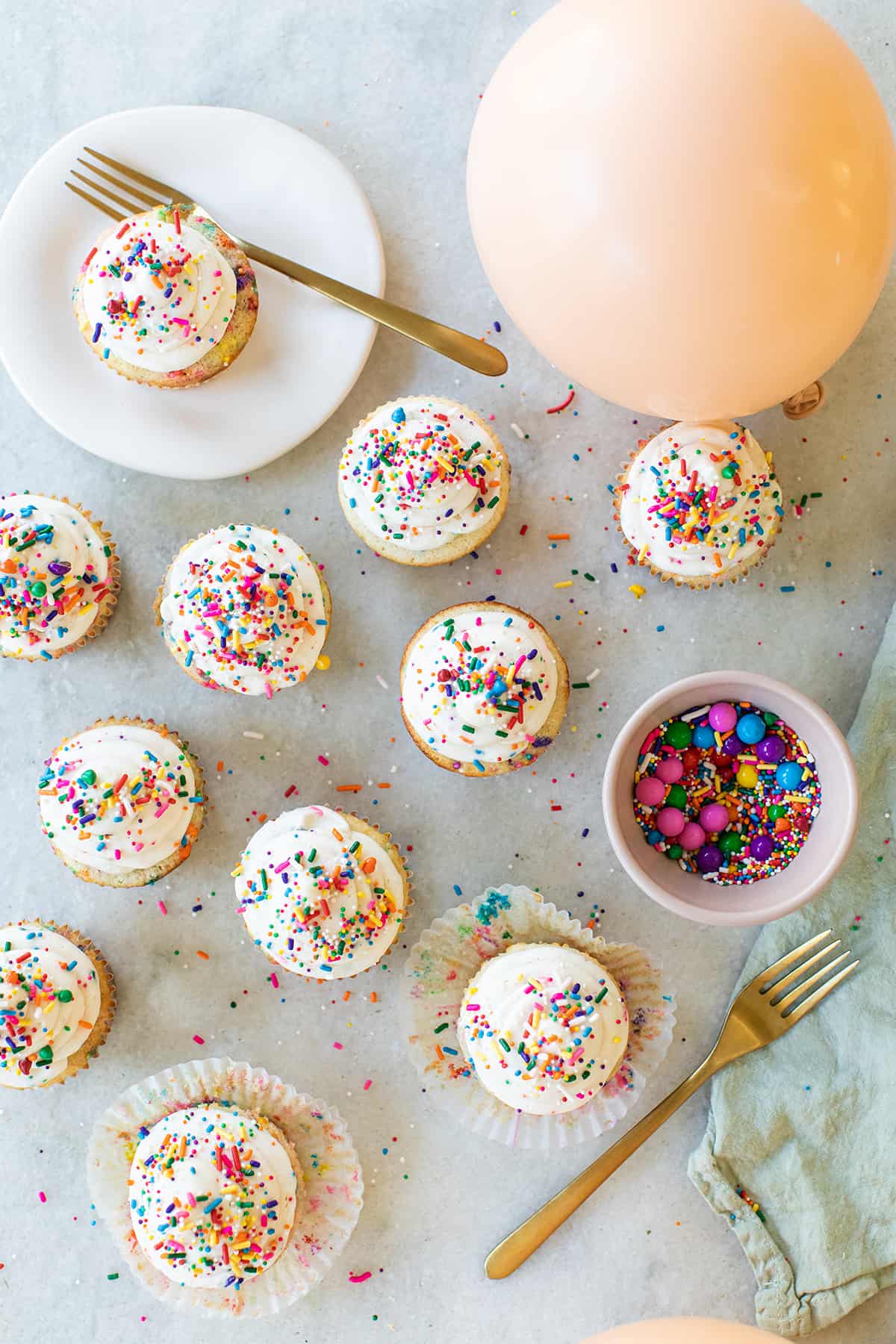 Birthday party cupcakes with sprinkles.