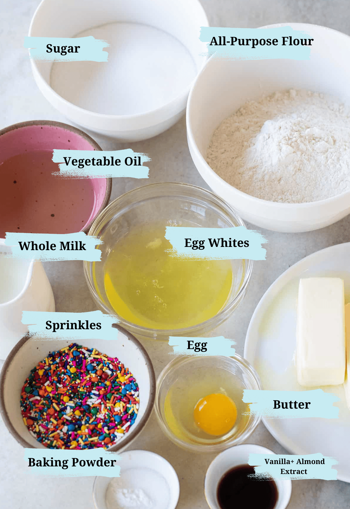 Confetti cupcake ingredients in bowls with titles to show what they are. 