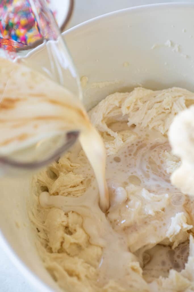 Alternating dry ingredients and wet ingredients.