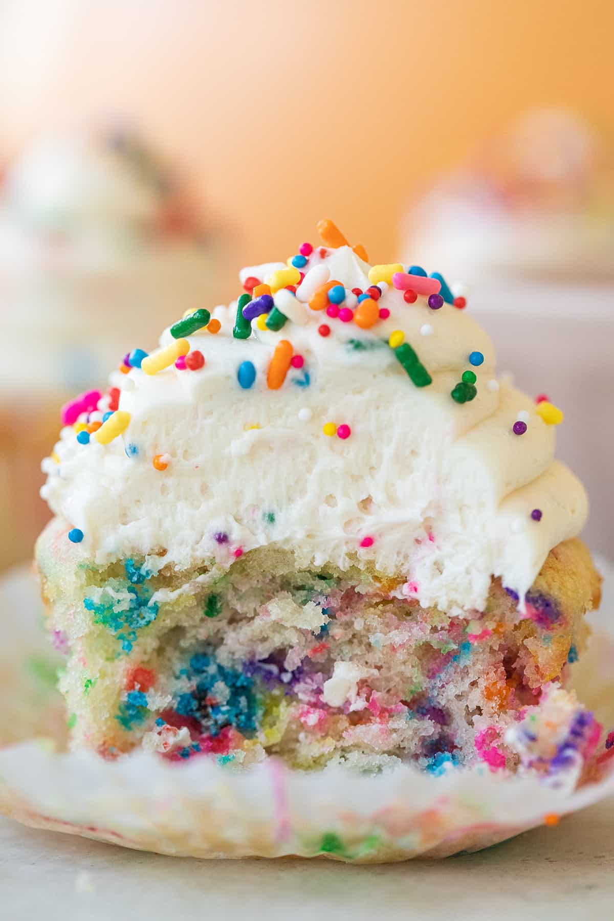 Confetti cupcake with bite taken out.