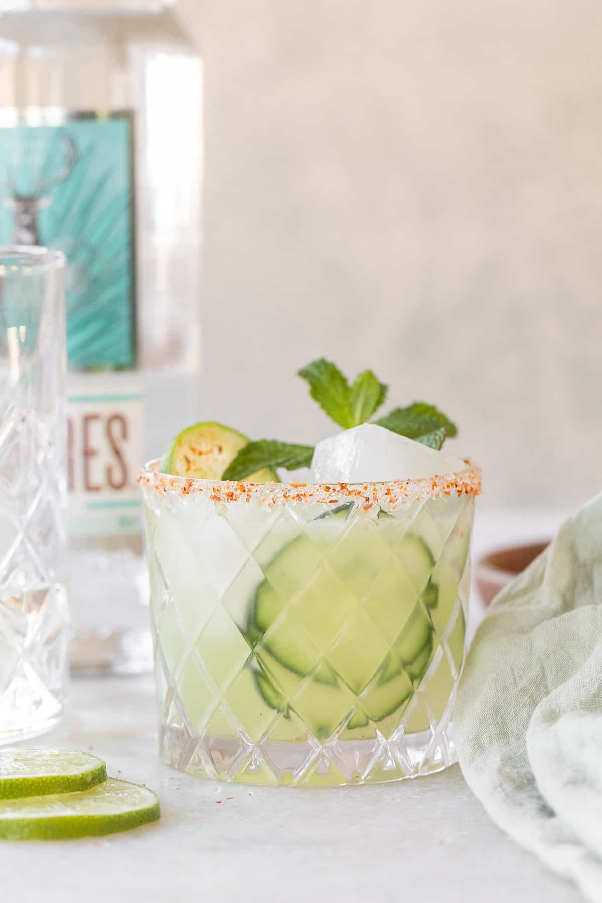 Refreshing margarita with cucumber slices, lime and mint.