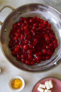 Canned cherry pie filling in a skillet.