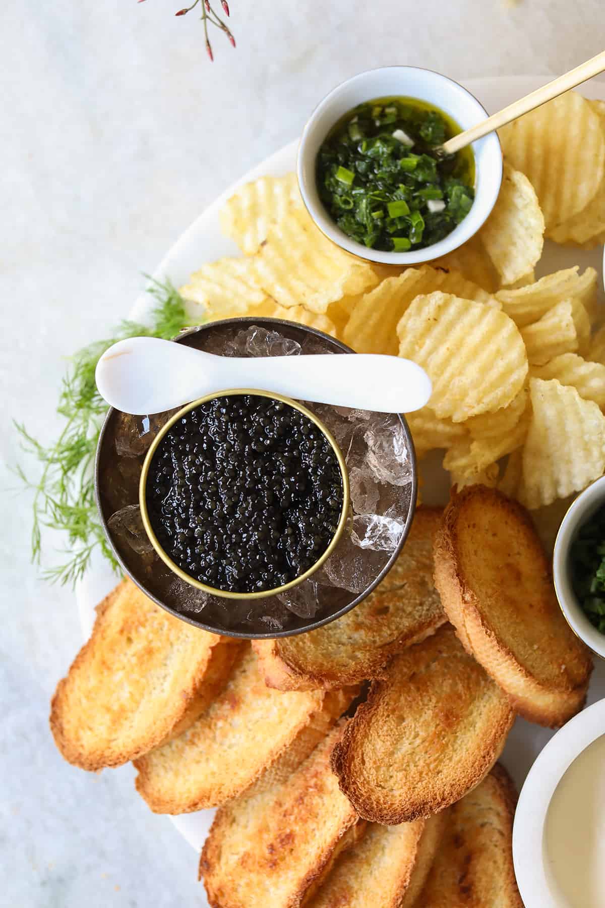 Black caviar with Mother of pearl spoon and chips.