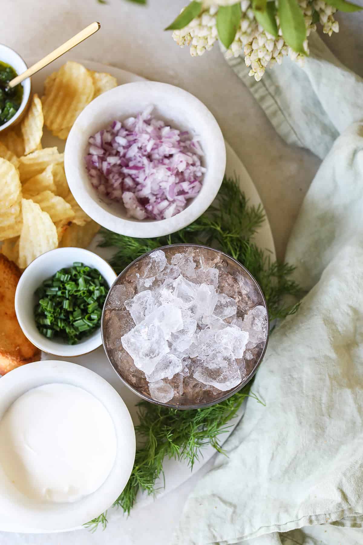 Ice in a bowl with dips to make a caviar platter.