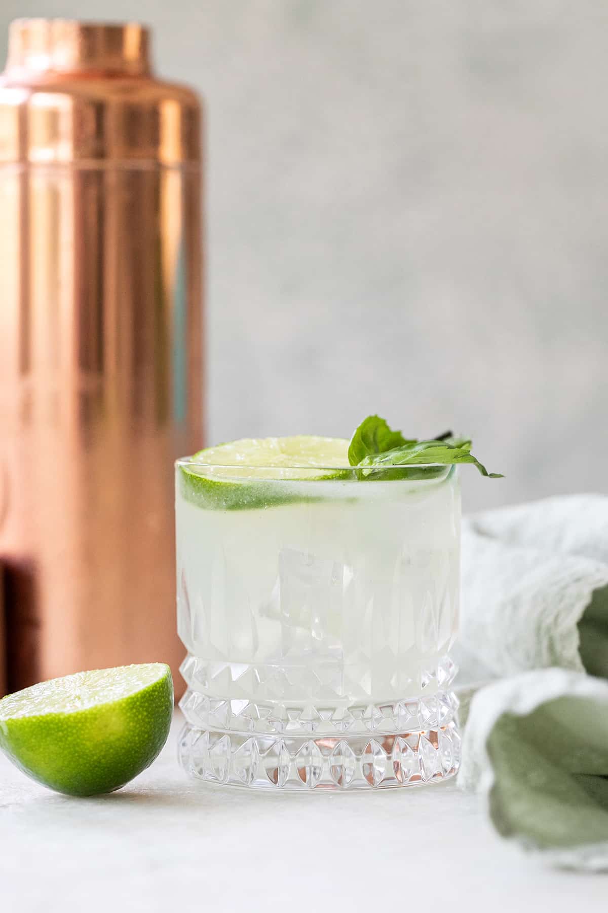 Gin basil smash cocktail in a cocktail glass.