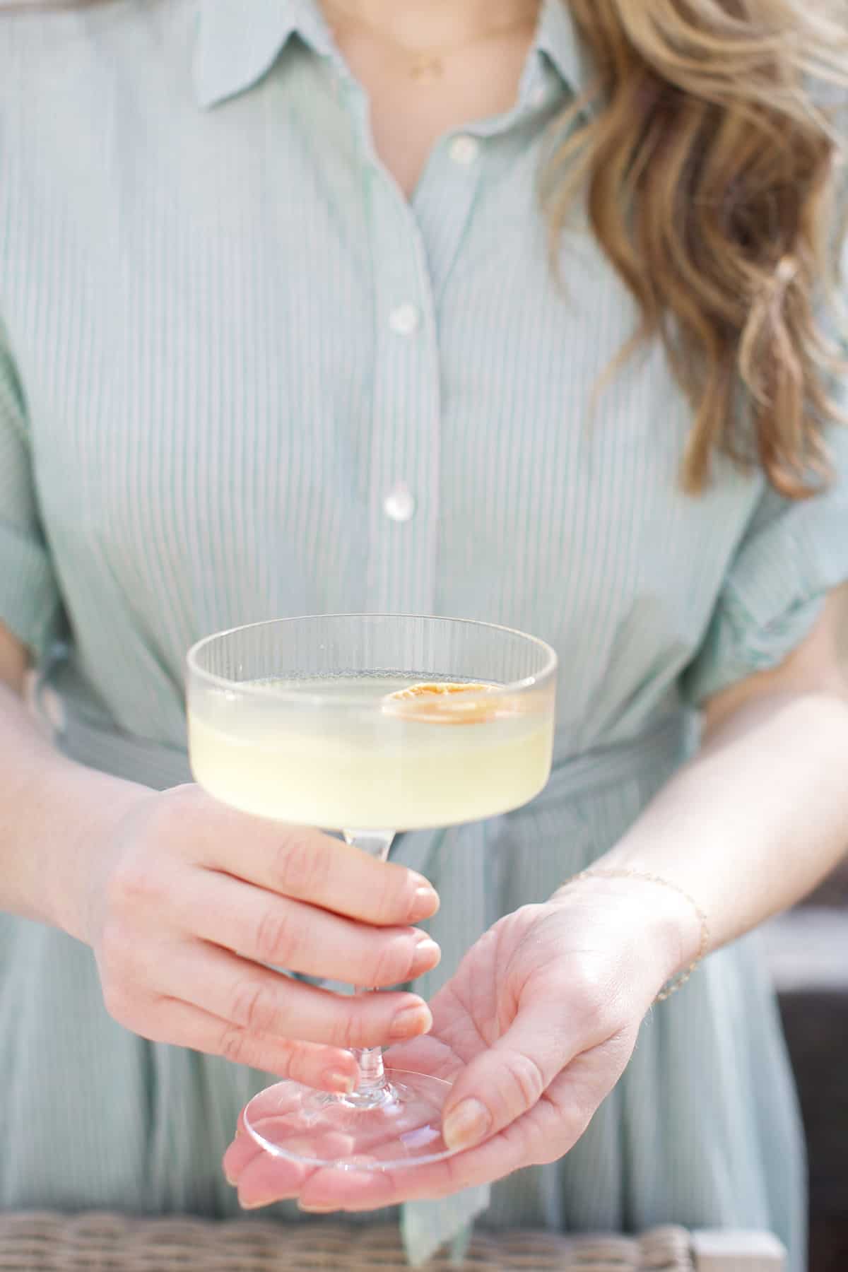 Eden Passante holding a lemon spritz cocktail.