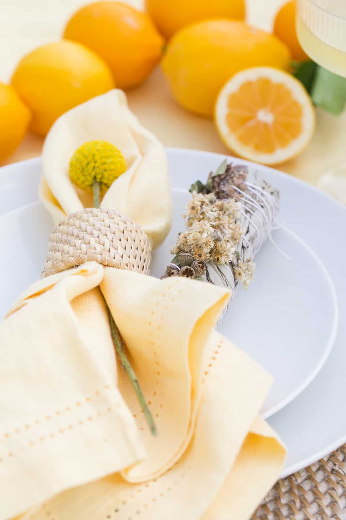 Yellow linen napkin with sage bundle.