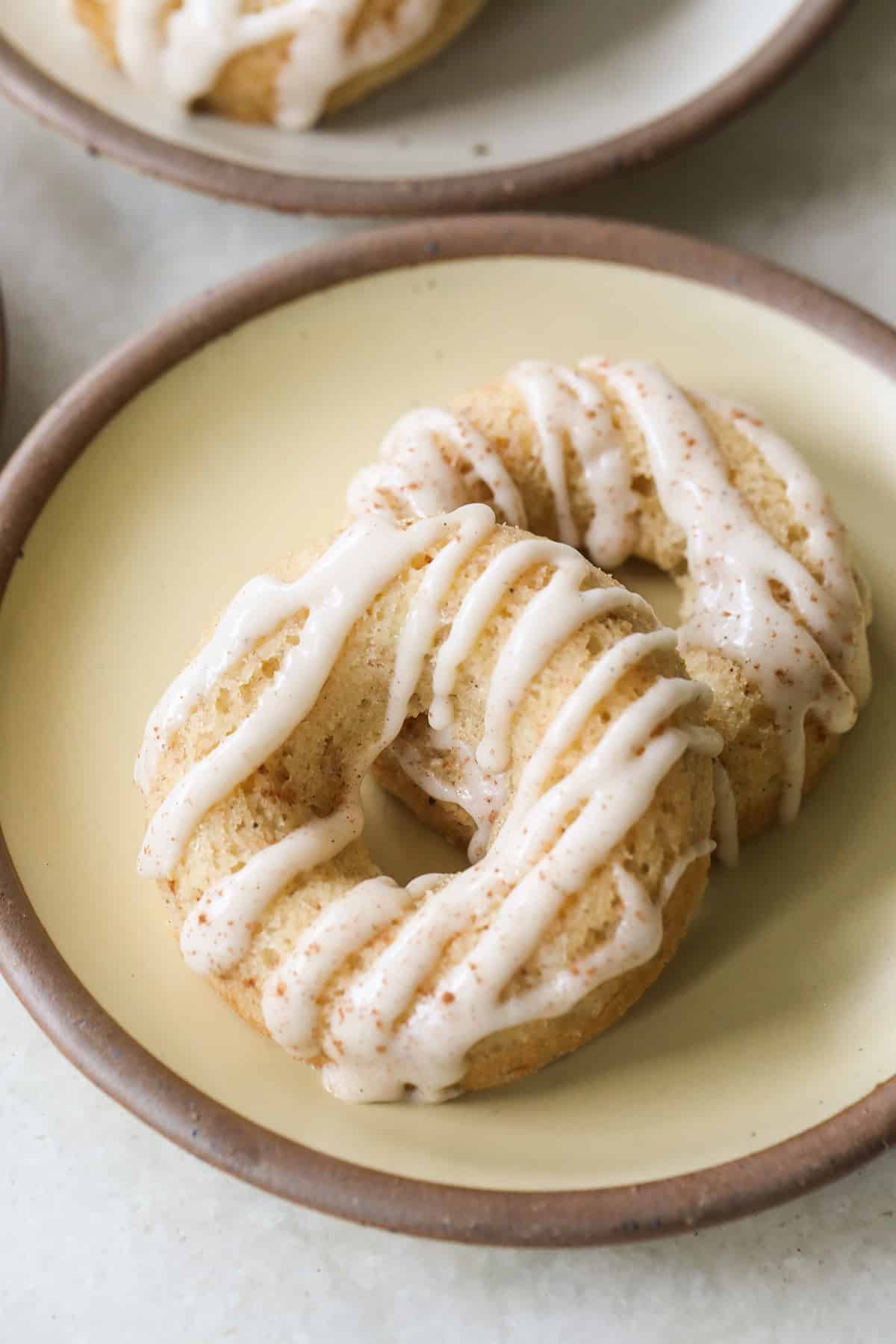 Banana donuts with glaze drizzled over the top. 