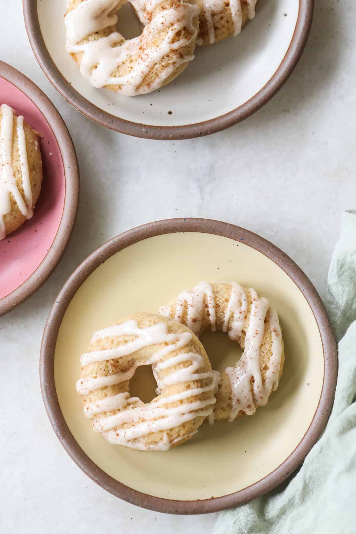 Baked banana donuts on plates.