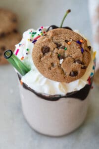 Chocolate chip cookie milkshake with a Chips Ahoy cookie on the top.