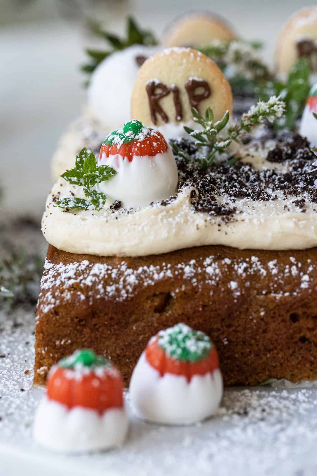 Graveyard cake with chocolate-dipped strawberry ghosts.