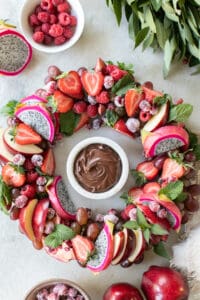 Christmas wreath platter with red fruit and chocolate dip.