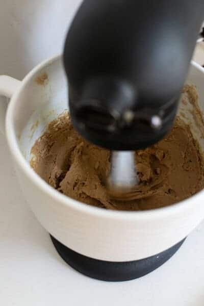 Gingersnap cookie dough in a mixer.