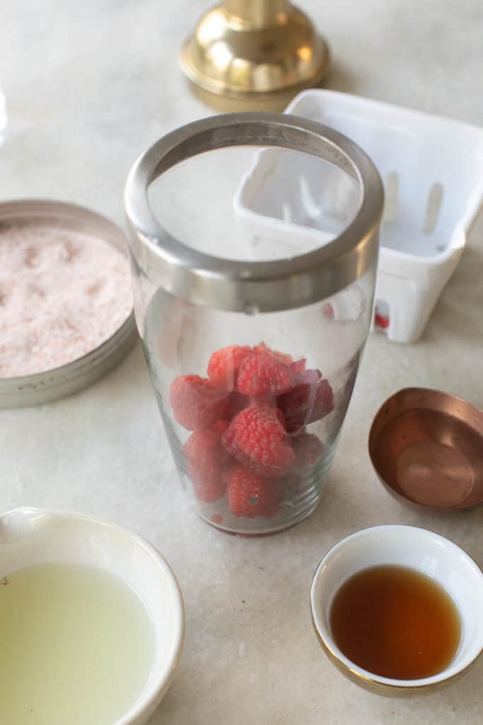 Raspberries in a cocktail shaker ready to be muddled,
