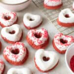 Heart-shaped donuts with sprinkles and glaze.