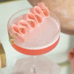 Bubble gum cocktail recipe with pink bubble gum garnish.
