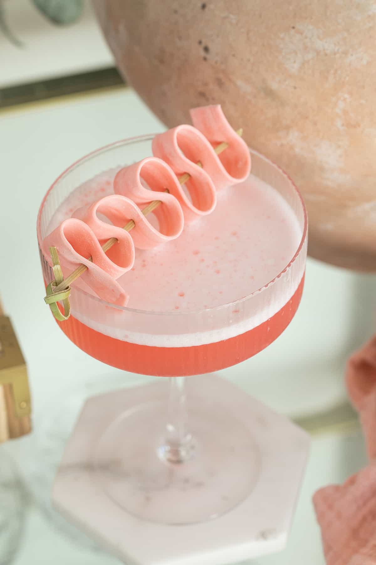 Bubble gum cocktail recipe with pink bubble gum garnish.