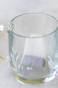 Brewing Earl Grey tea in a clear glass mug.