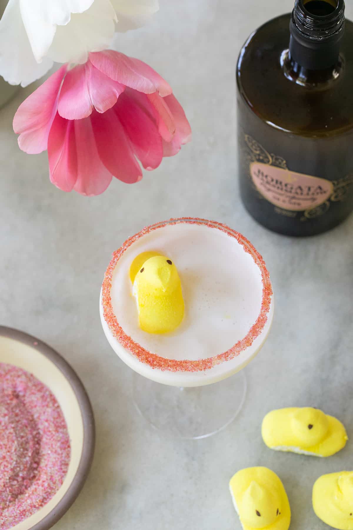 Peep marshmallow martini with pink sugar and a yellow peep garnished on the top.