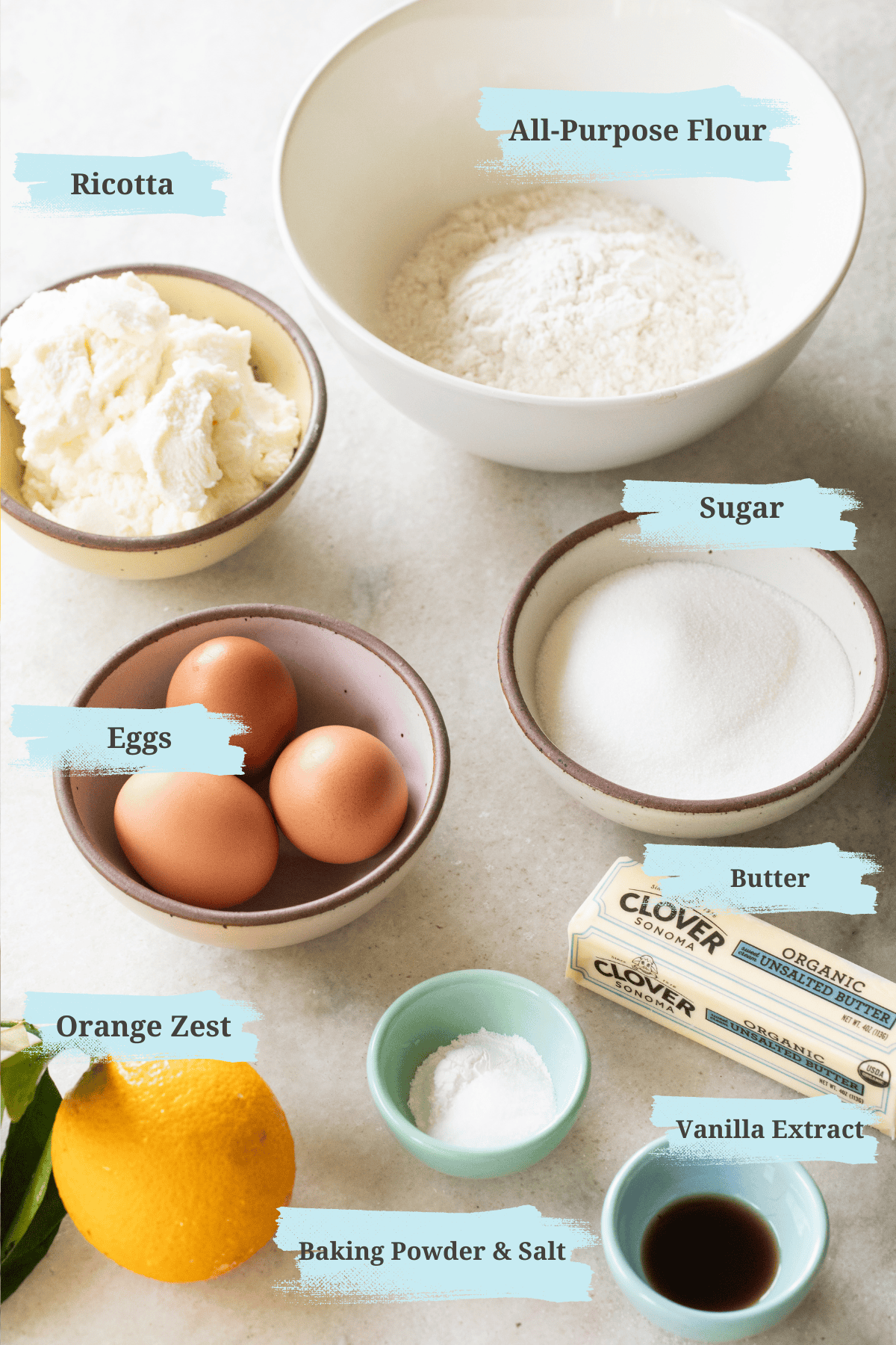 Ricotta, flour, sugar, butter, eggs, vanilla extract, orange zest, baking powder and salt in small bowls.