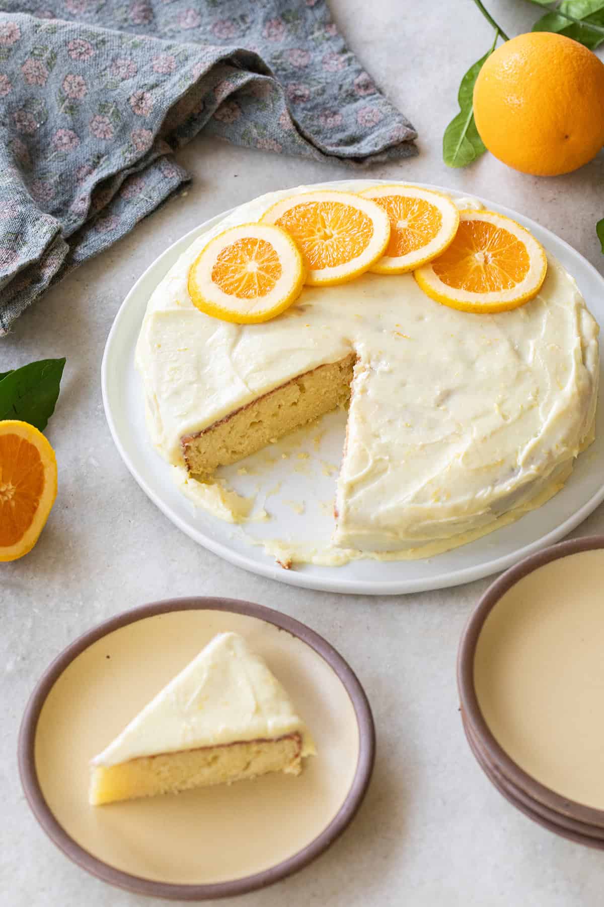 Easy, super moist ricotta cake with orange slices and orange icing over the top.