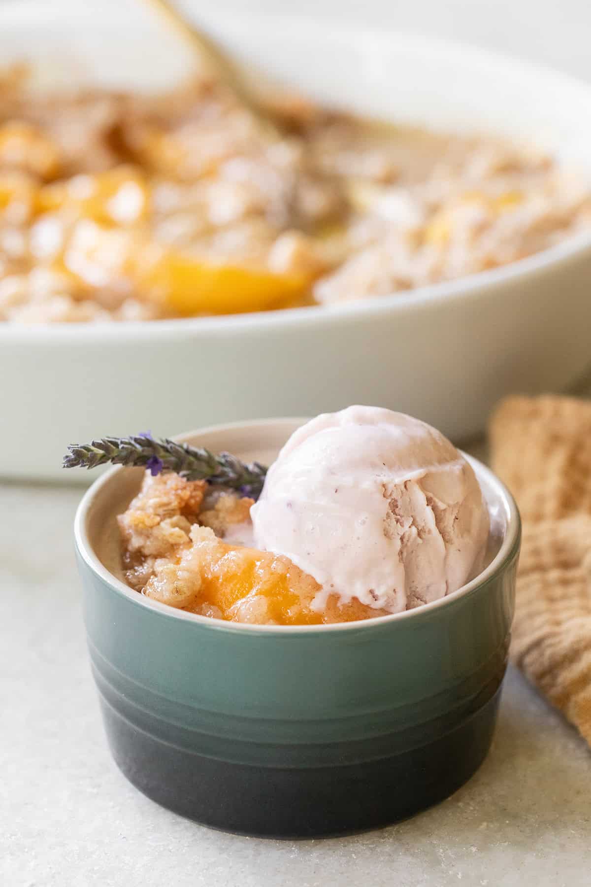 Canned peach crisp topped with strawberry ice cream.