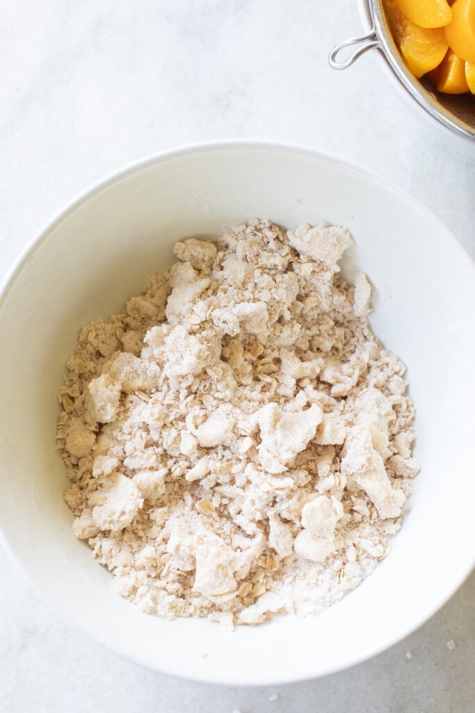 Butter, flour, sugar, salt and cinnamon crumbled together in a bowl.