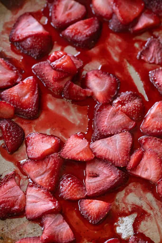 Roasted strawberries on a baking sheet.