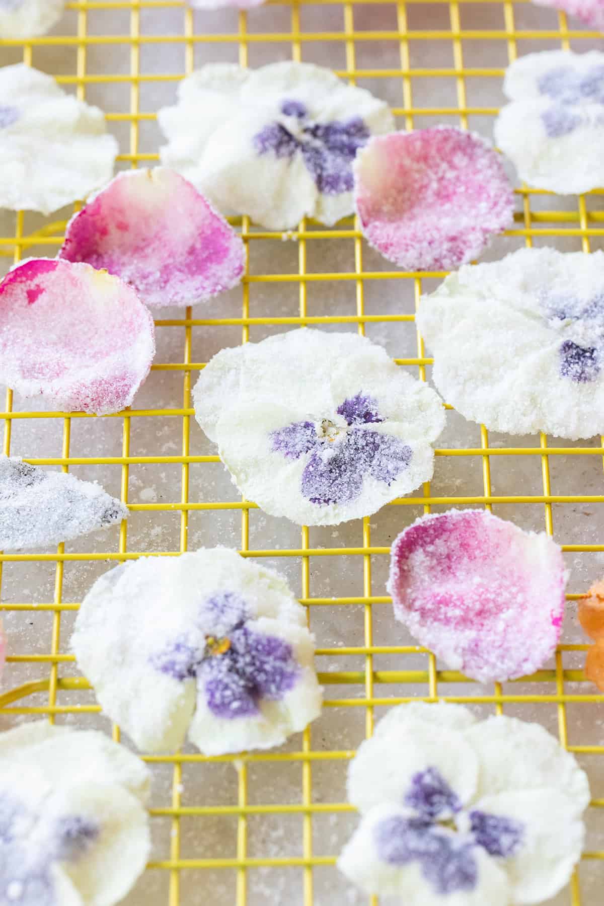 Edible sugar flowers drying on a cooling rack. 