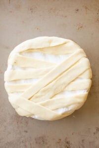 Brie wheel wrapped in puff pastry slices.