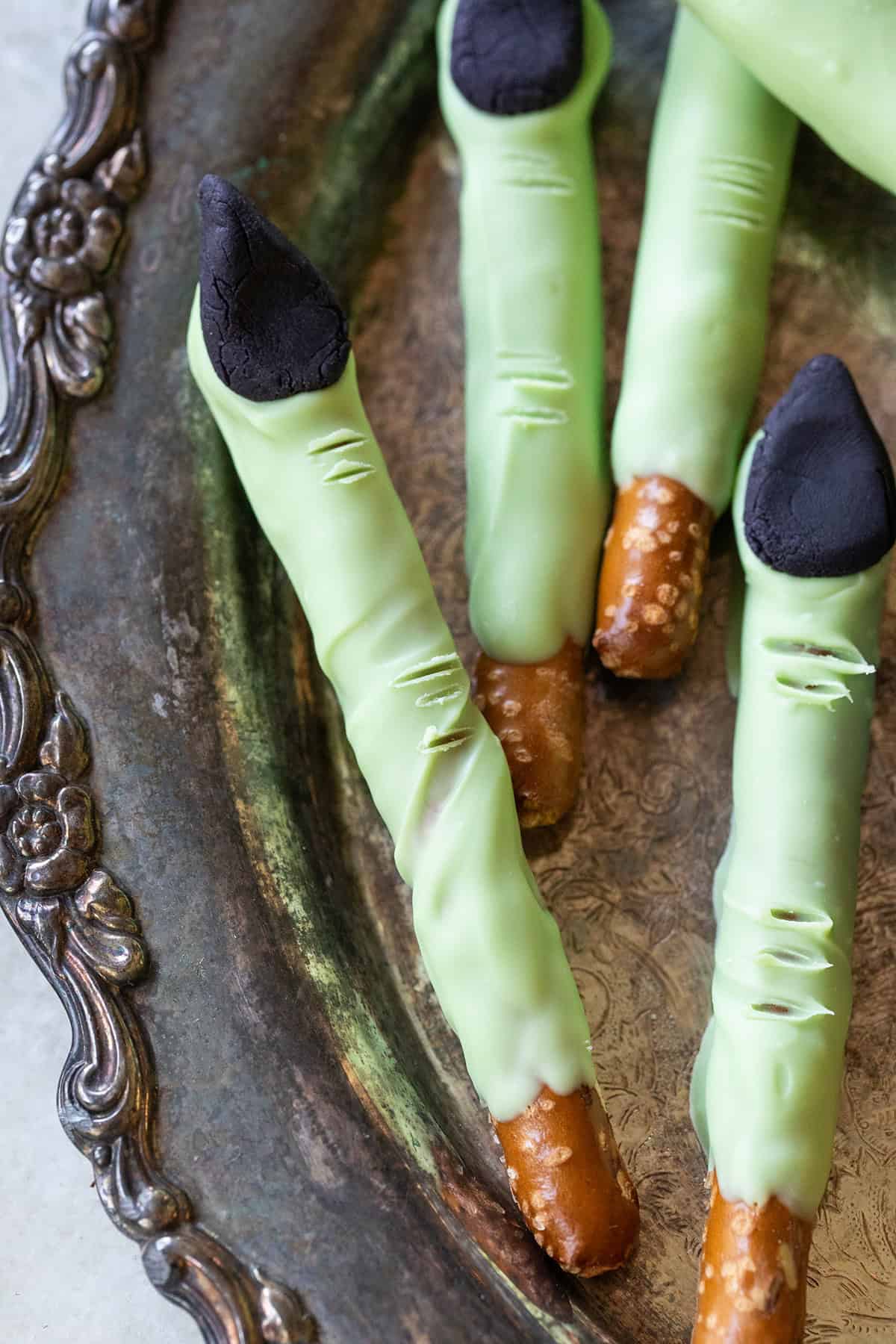 Chocolate covered pretzels dipped in green candy melts to make witch fingers.