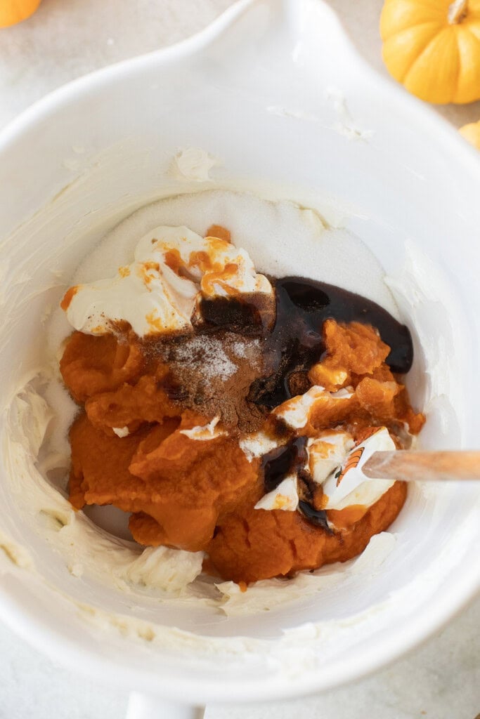 Ingredients in a bowl to make pumpkin cheesecake.