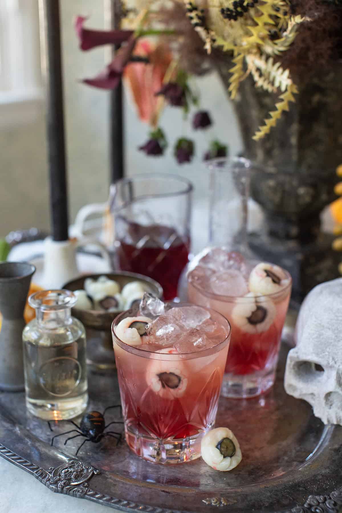 Cranberry cocktail in a Halloween setting with lychee eyeballs. 