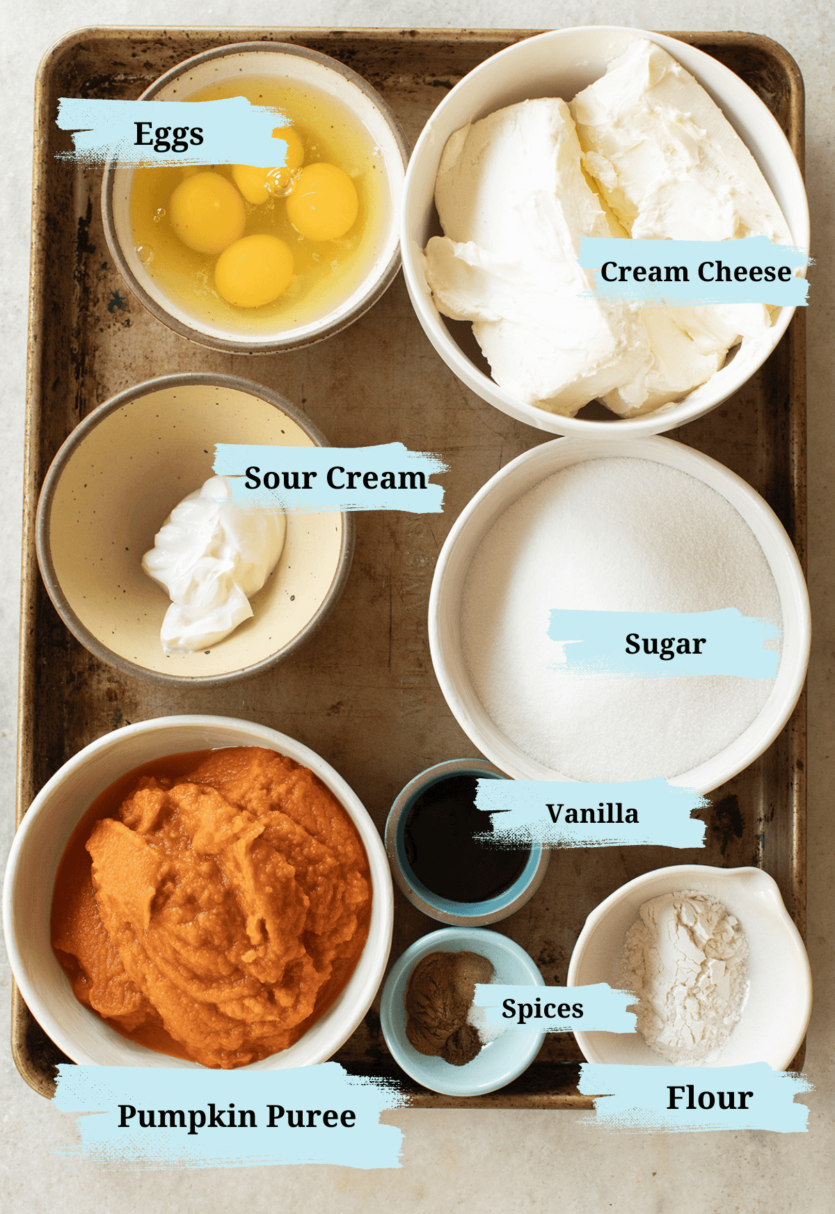 Ingredients in bowls to make pumpkin cheesecake.