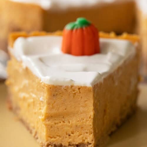 Creamy pumpkin pie recipe with a slice taken out of it.