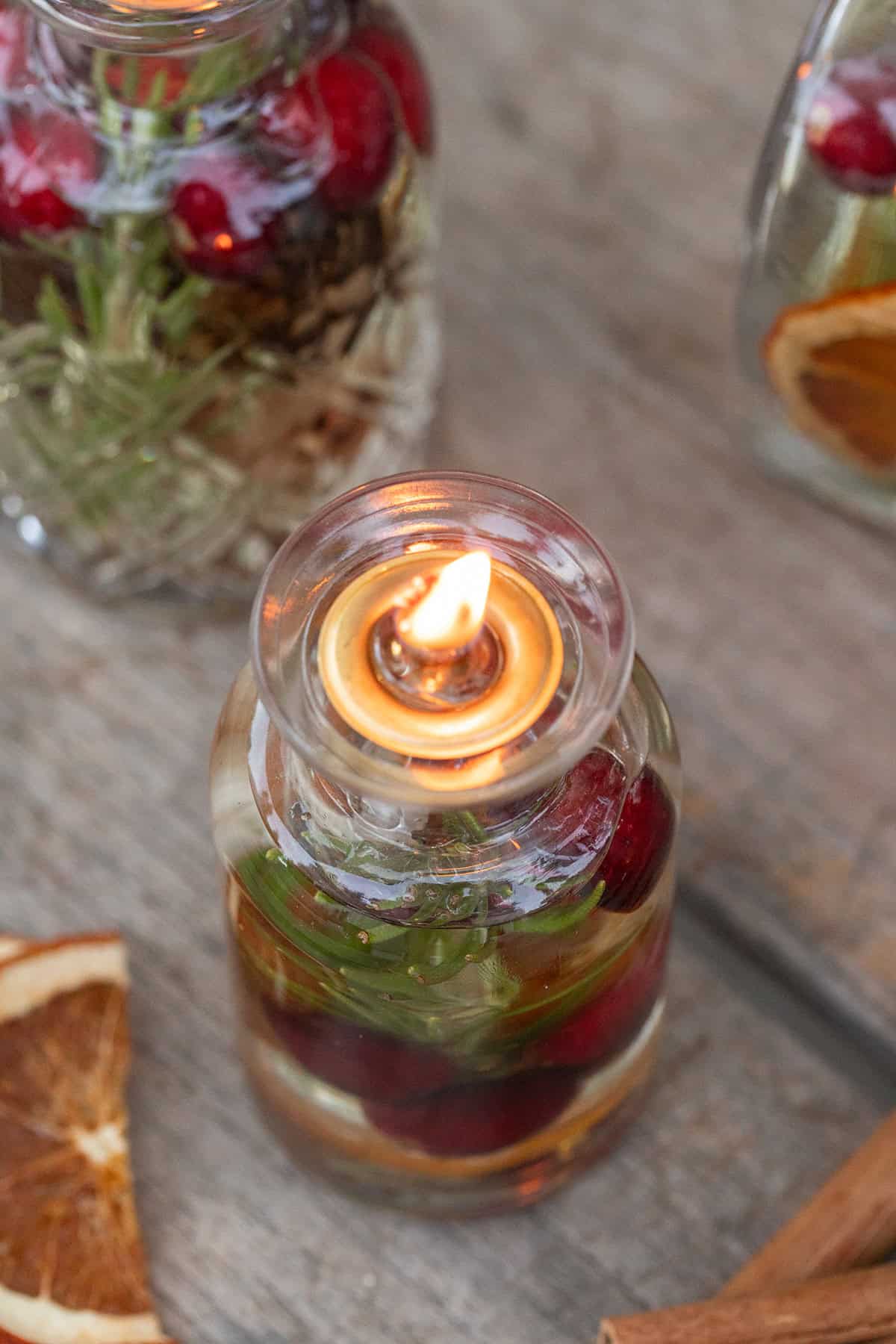 A homemade oil candle lit on a table for a party.