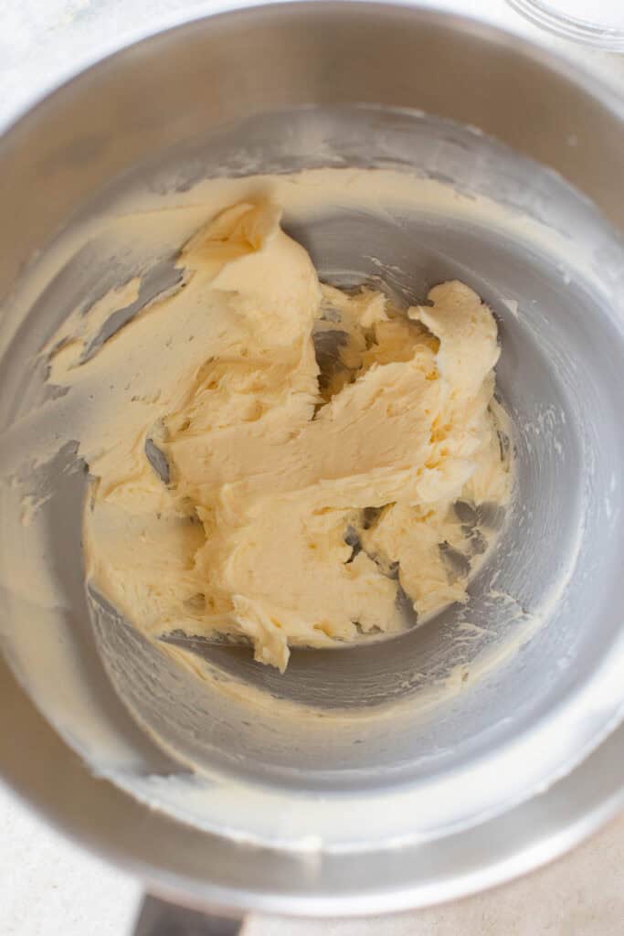 Creaming butter together in a mixing bowl.