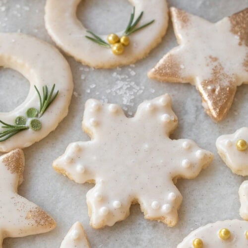 Cutout shortbread cookies decorated with sprinkles.