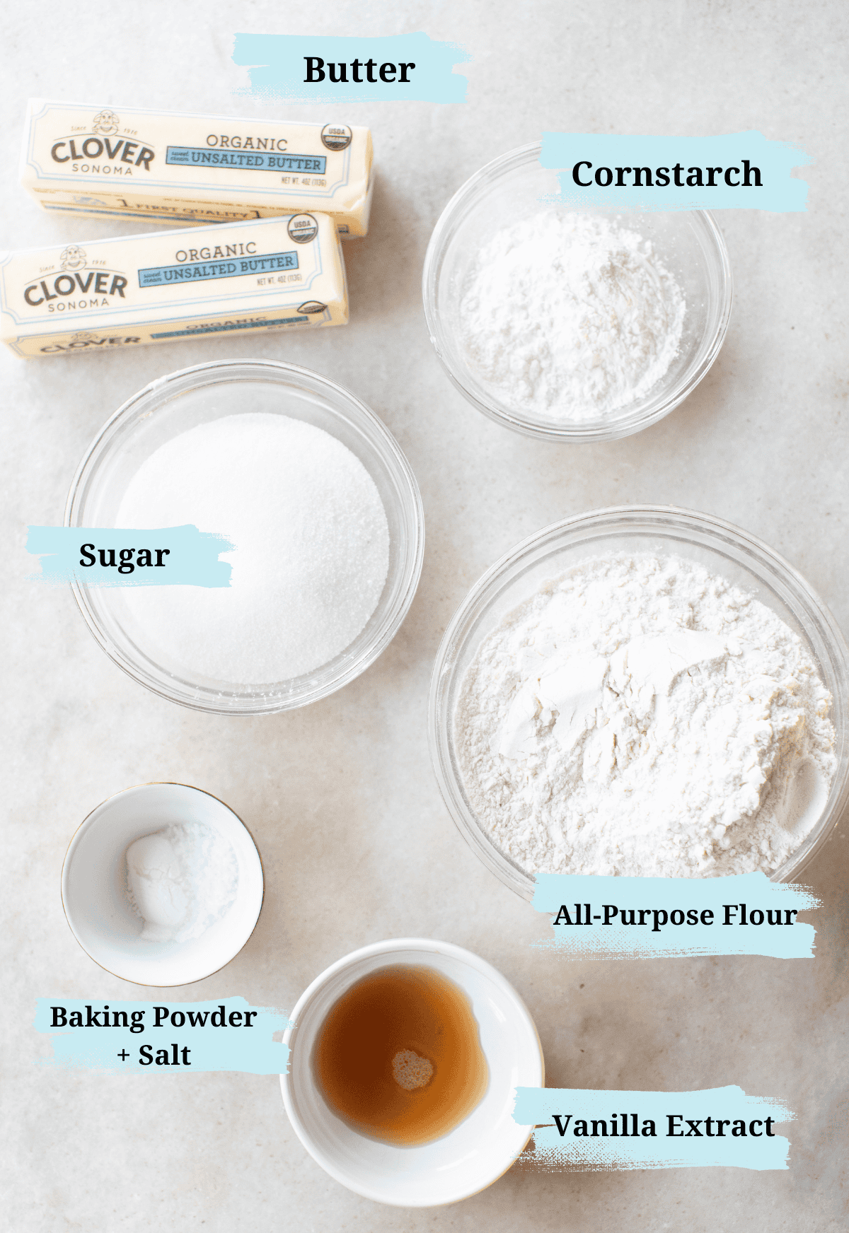 Flour, sugar, salt, butter, vanilla extract, baking powder in bowls.