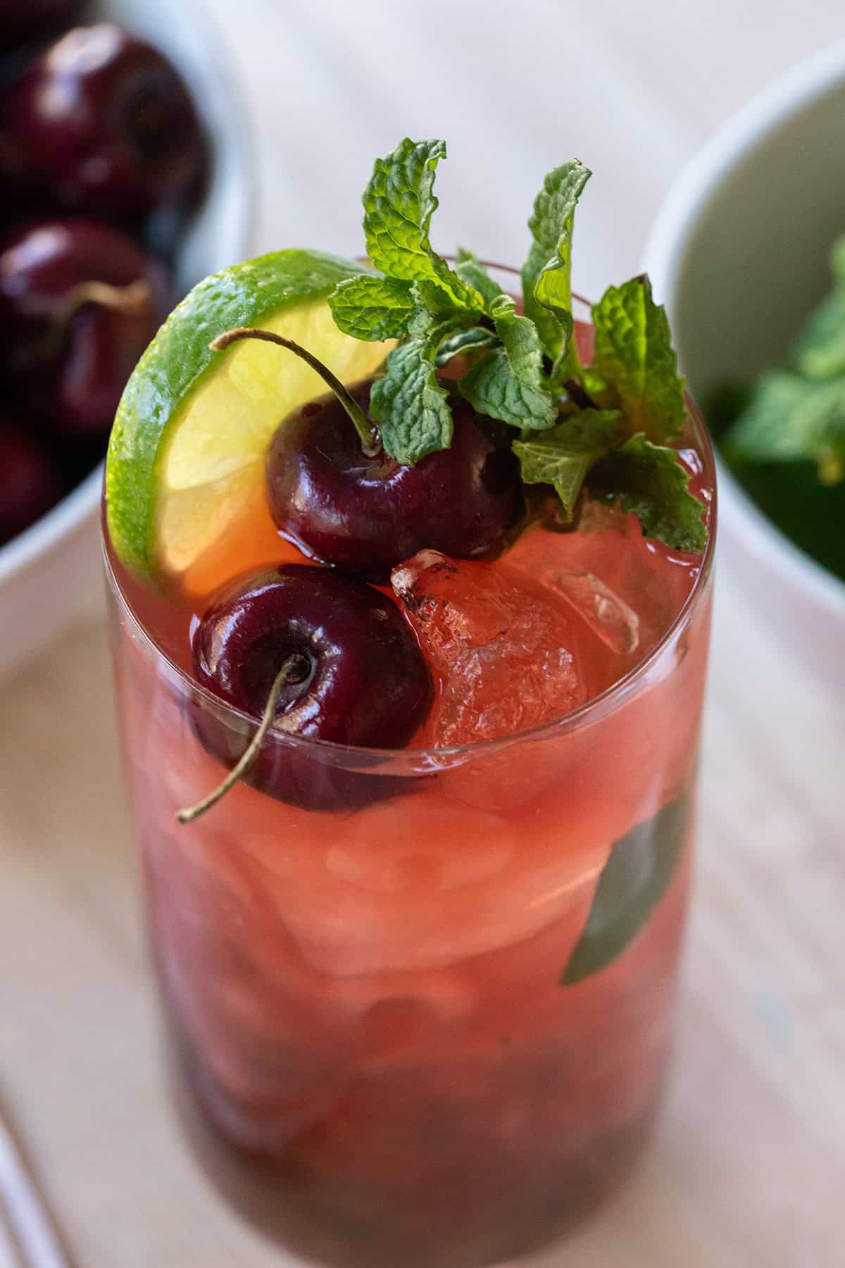 Cherry mojito with fresh mint and cherries on the top.