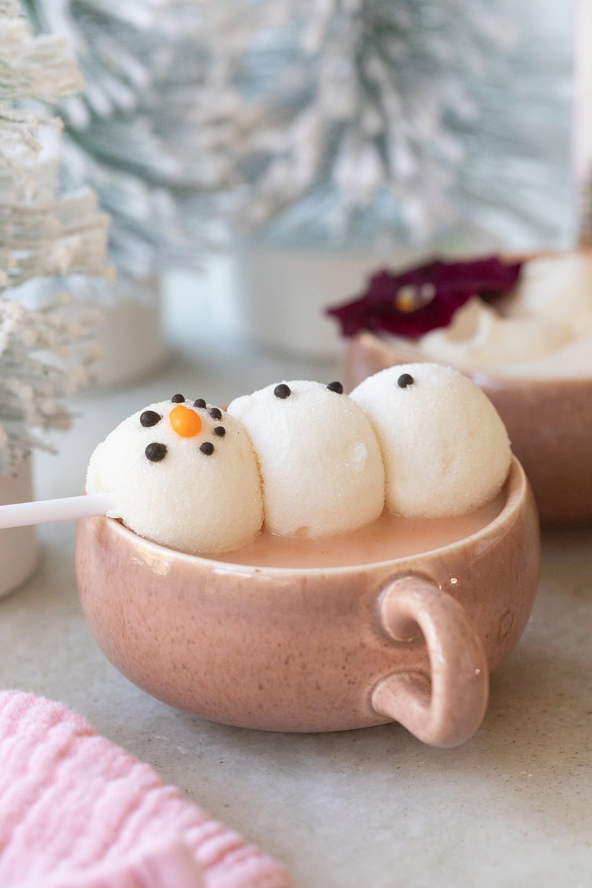 Pink hot chocolate with a snowman marshmallow. 