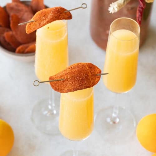 Mango mimosa recipe with mango juice and Prosecco.