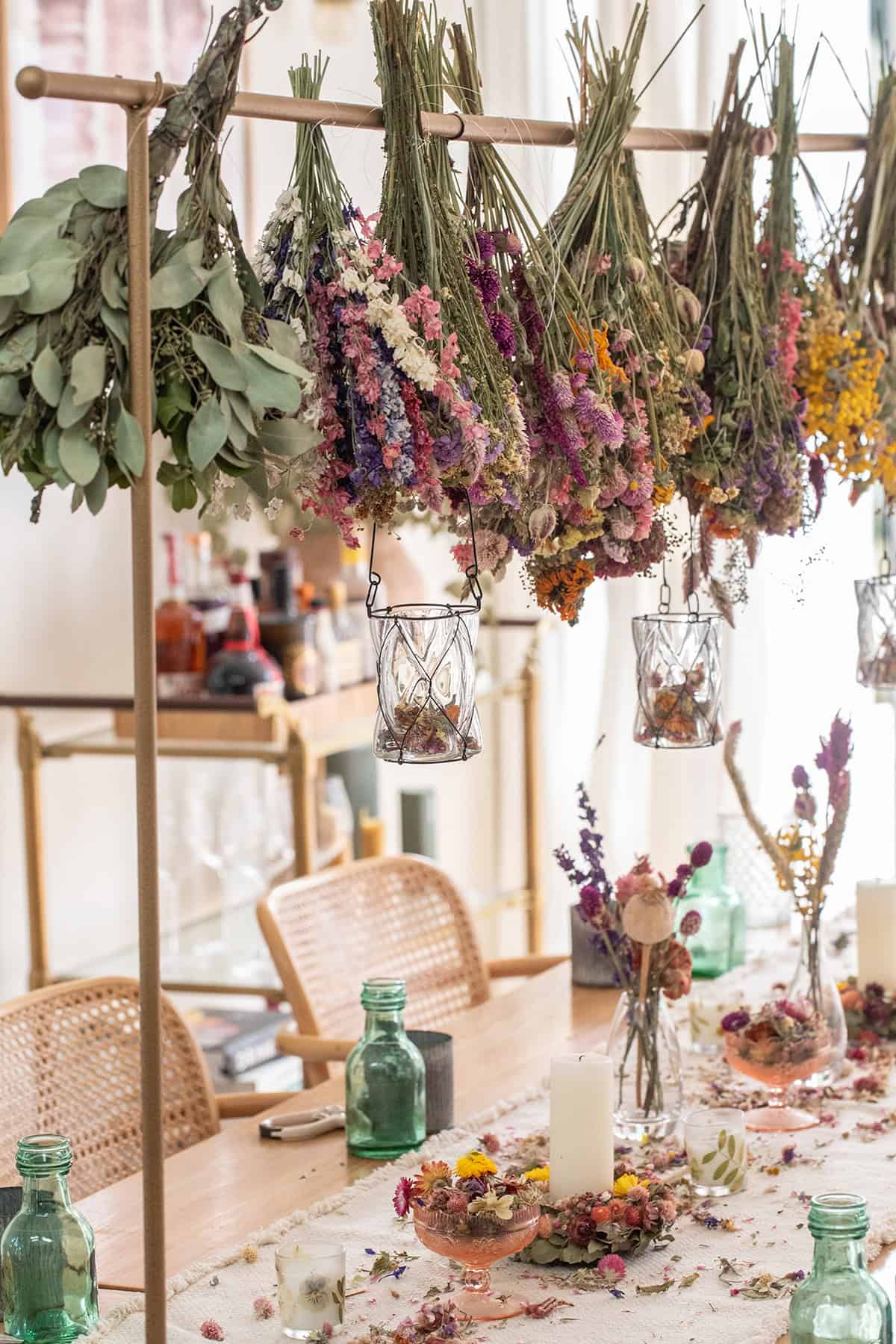 Dried flowers hung from a gold bar. 